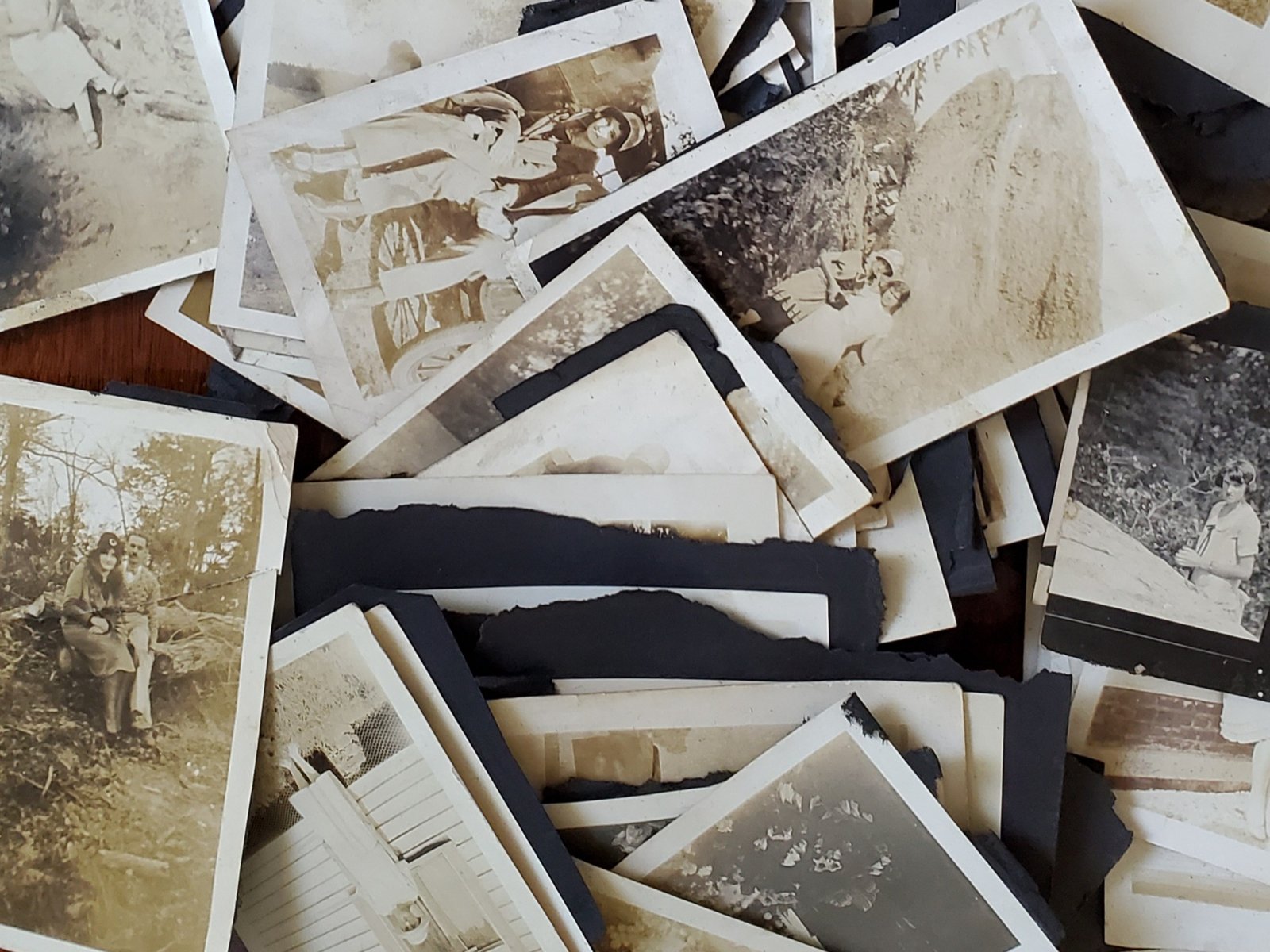 Old black-and-white family photographs waiting to be organized and scanned
